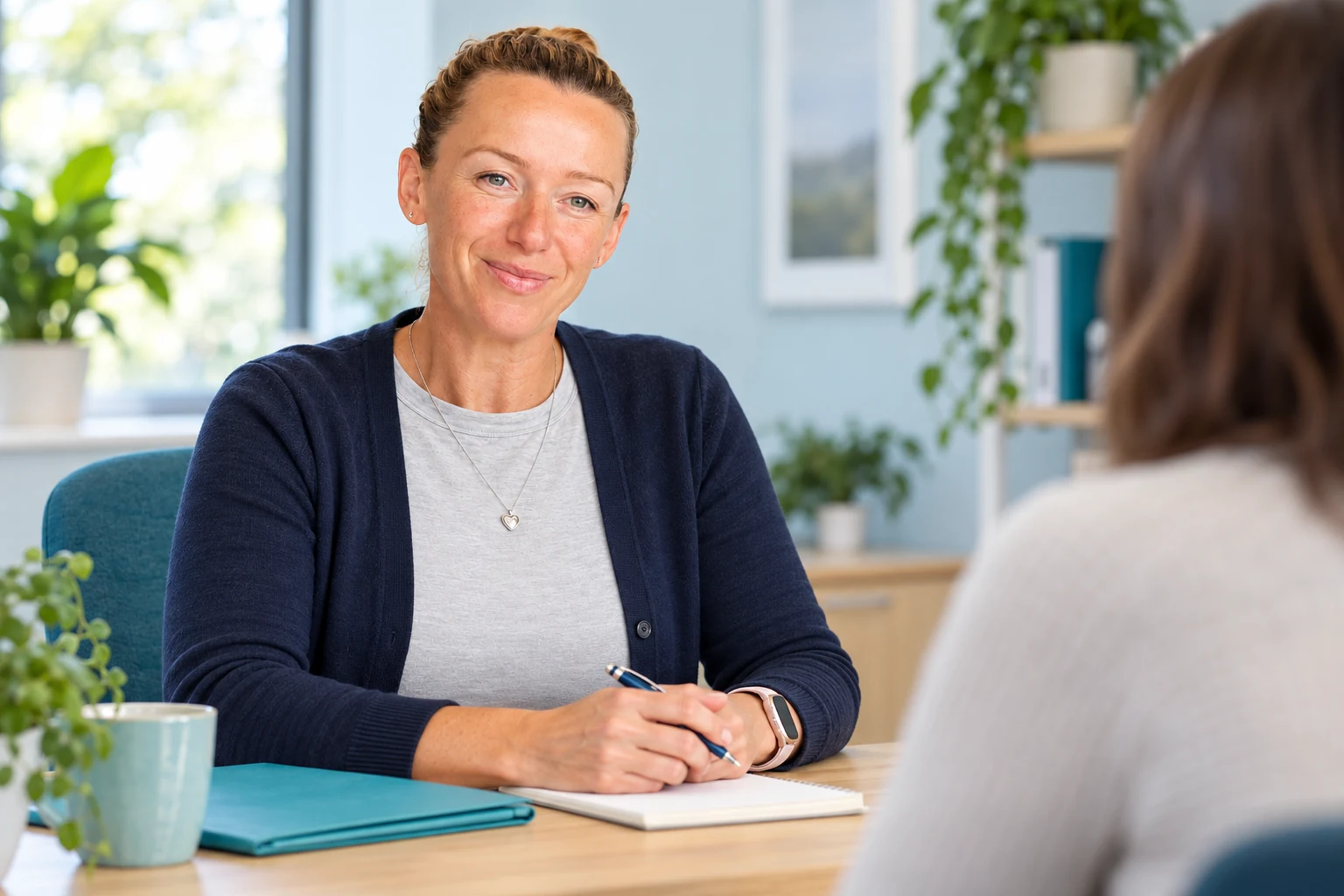 Suzanne listening to an employee during a workplace wellbeing discussion.